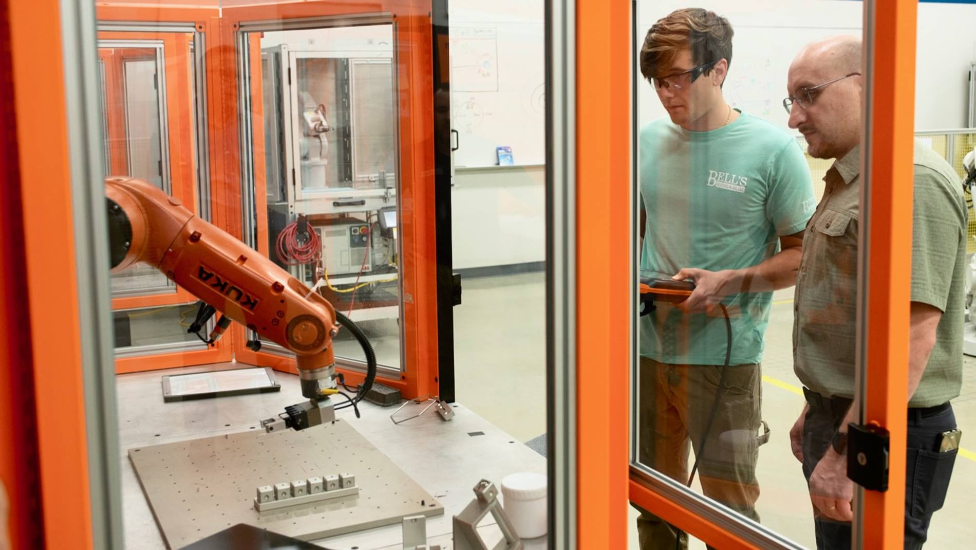 Yuri Denishchich training students with KUKA's ready2_educate cell